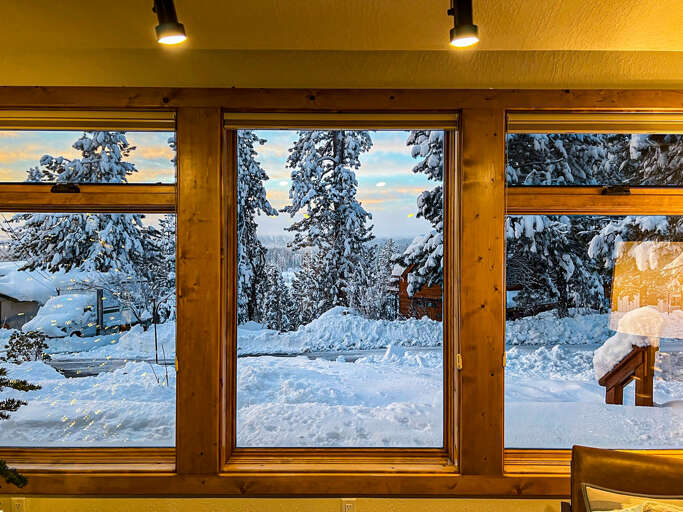 Cozy up and take in the magical views out the front windows after a fresh winter snowfall — the perfect mountain retreat vibe.
