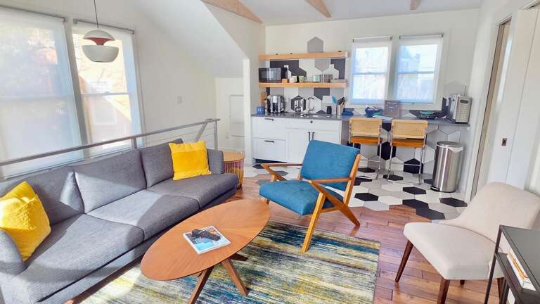 Bright Lounge, Geometric Kitchen, Colorful Seating, Wooden Floors