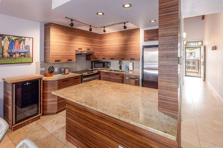 Kitchen With Sleek Surfaces And Spacious Setup