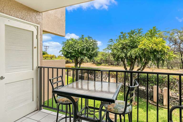 Balcony With Table And Chairs Overlooking A Garden
