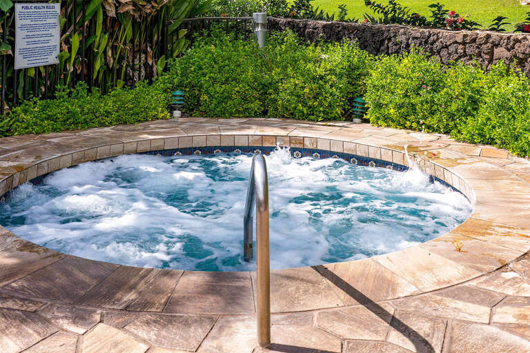 Bubbling Backyard Jacuzzi Bordered By Lush Green Grass