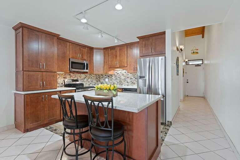 Interior Of A Residential Kitchen With Island And Bar Stools