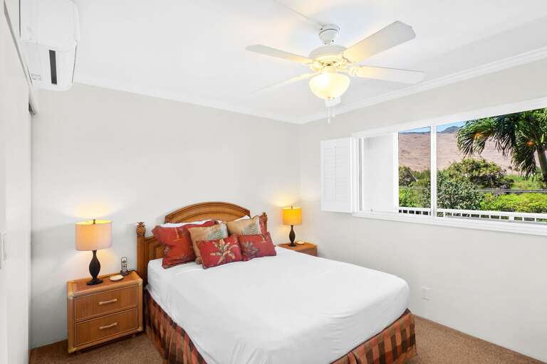 Bedroom With Beige Walls, Bed With Headboard, Ceiling Fan, And Window View Of Greenery Bedroom With Beige Walls, Bed With Headboard, Ceiling Fan, And Window View Of Greenery