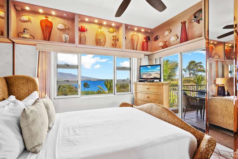Bright Bedroom With Bed, Seashells, Ceiling Fan, And Scenic Sea View