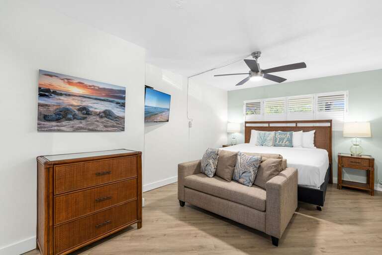 Vacation Rental Room With Beige Bed, Sandy Sofa, And Seaside Snapshots
