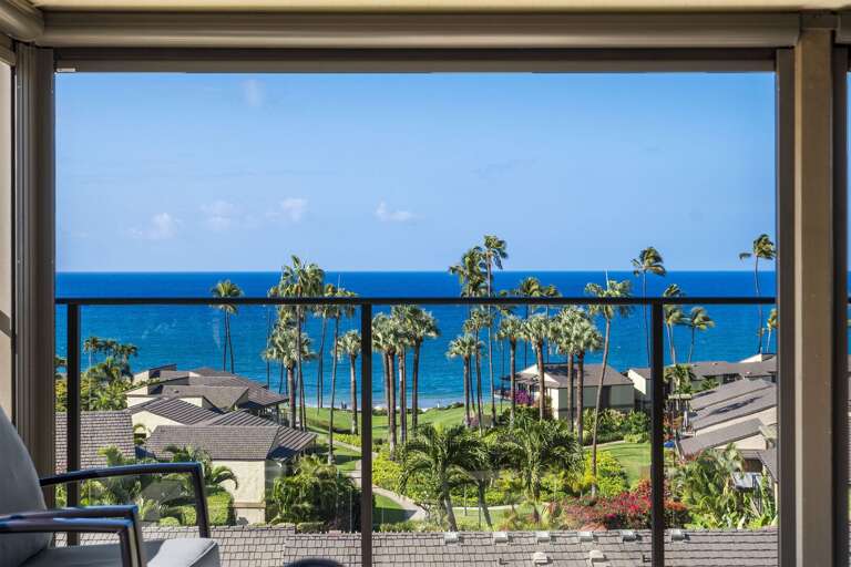 View Of Vibrant Seas Seen Through An Open Balcony, Towering Palms And Lush Landscape Visible