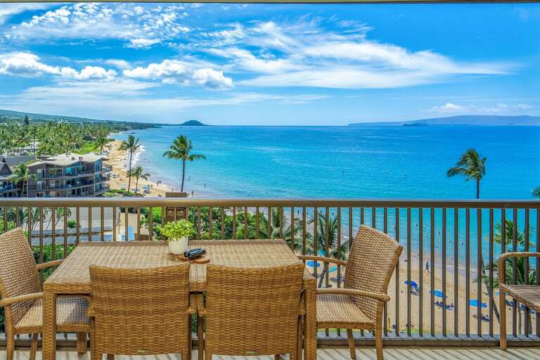 Balcony With Wicker Furniture Overlooking Beach And Ocean