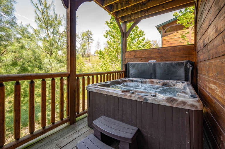 Wooden Balcony With Bubbling Hot Tub Overlooking Lush Greenery