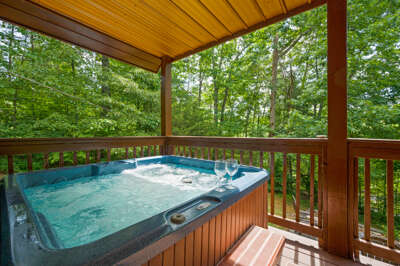 Jacuzzi On Wooden Deck Surrounded By Lush Green Trees