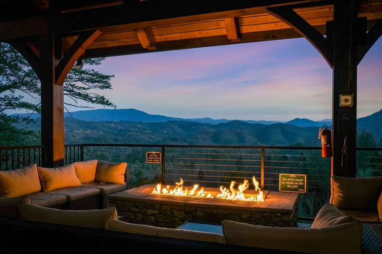 Firepit With Flickering Flames, Surrounded By Seating, Overlooking Mountain Vista At Sunset