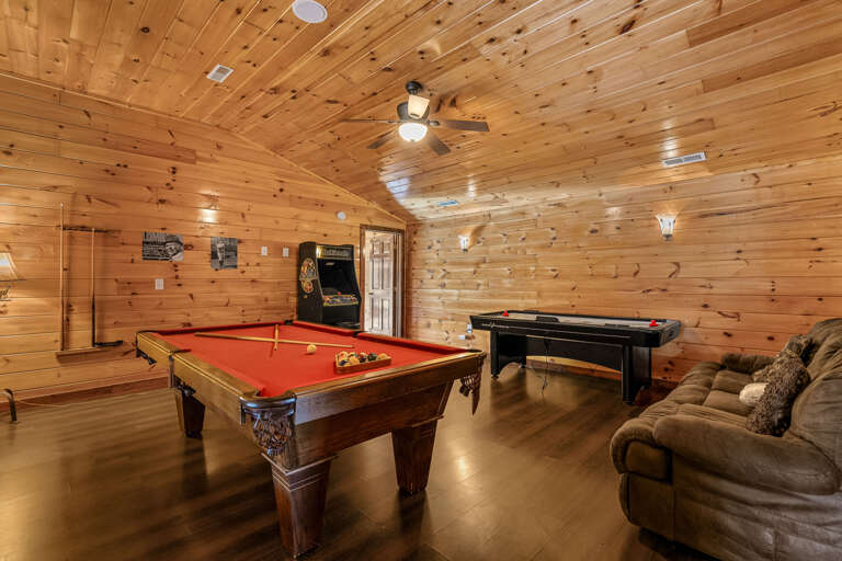Wood-lined Room With Red Billiards Table And Arcade Game