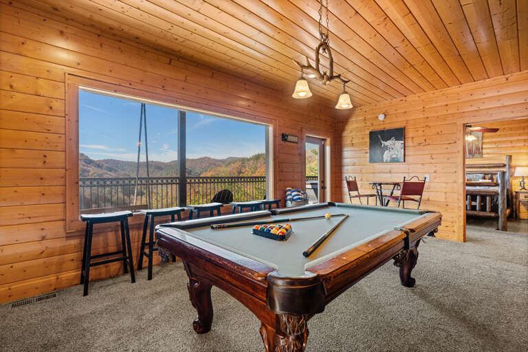 Wood-walled Room With Billiards Table, Large Window View Of Mountains