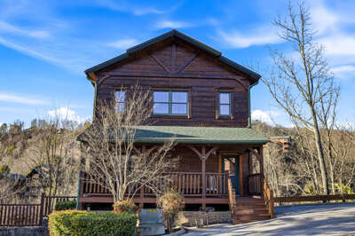 Wooden Cabin With Trees, Porch, And Blue Sky