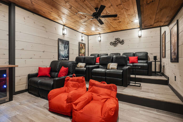 Plush Seating, Red Accents, Wooden Walls, Dim Lighting