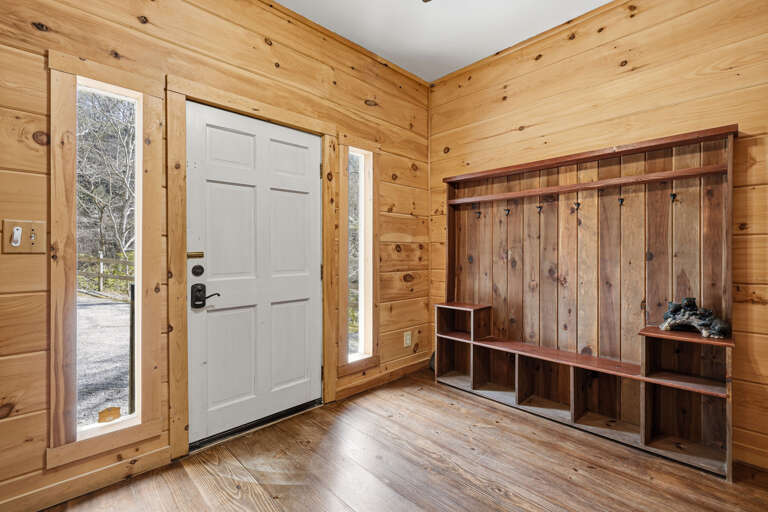 Wood-paneled Entryway With Cubbies And Coat Hooks