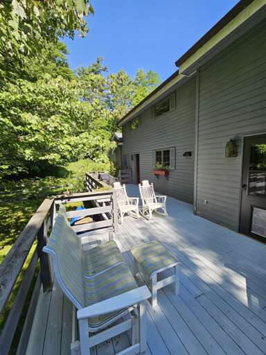 Deck with dining area and slider into kitchen area