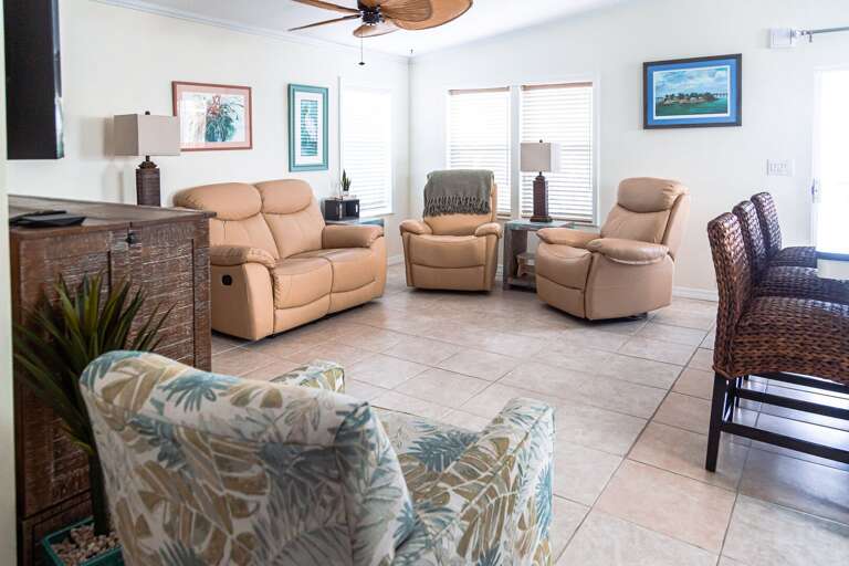 Vacation Rental Living Room With Beige Recliners And Tiled Floor
