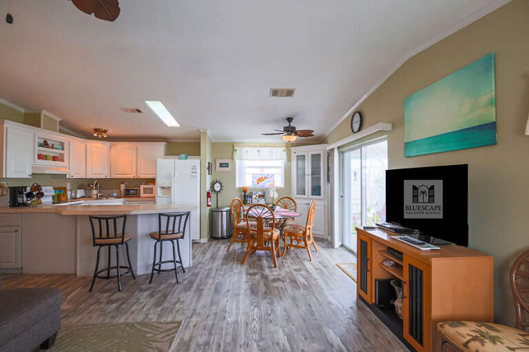 Spacious Living Space Sporting Sleek Surfaces And A Splash Of Sea-toned Art