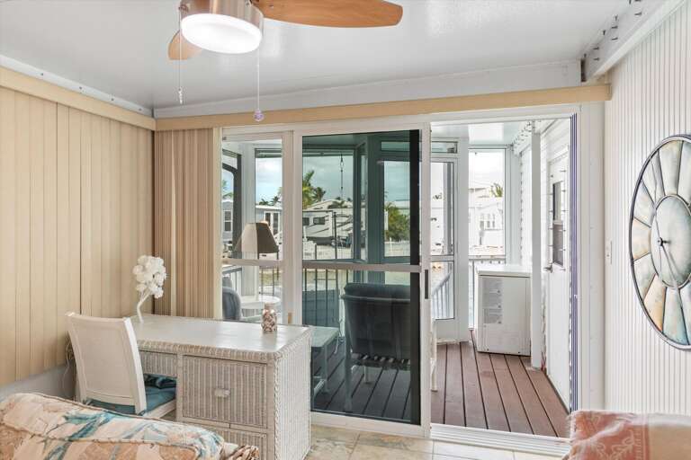 Beachside Vacation Rental Interior Showing A Sliding Door Leading To A Balcony With Seaside Views