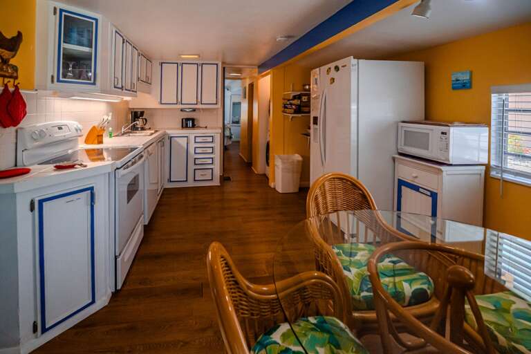 Vividly Vibrant Kitchen With Bamboo Chairs, Blue And White Cabinetry
