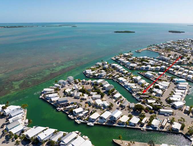 Aerial View Of Coastal Community With Blue Waters And Winding Waterways