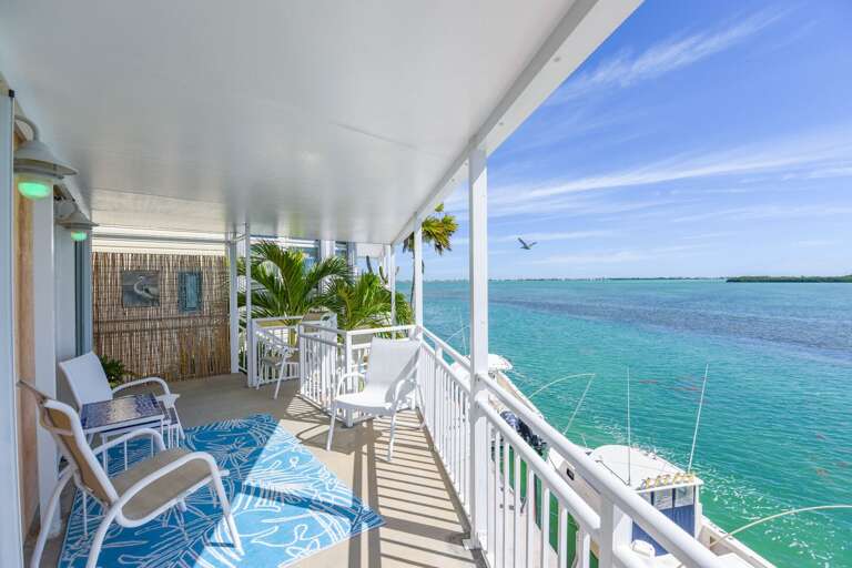 Balcony Breeze, Blue Seas, Chairs Face Endless Expanse Balcony Breeze, Blue Seas, Chairs Face Endless Expanse