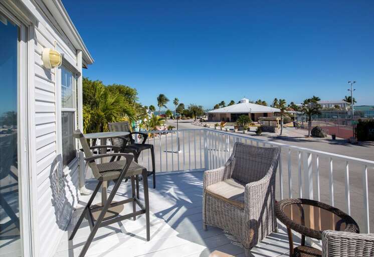 Sunny Balcony Scene With Seating And Scenic View At Vacation Rental