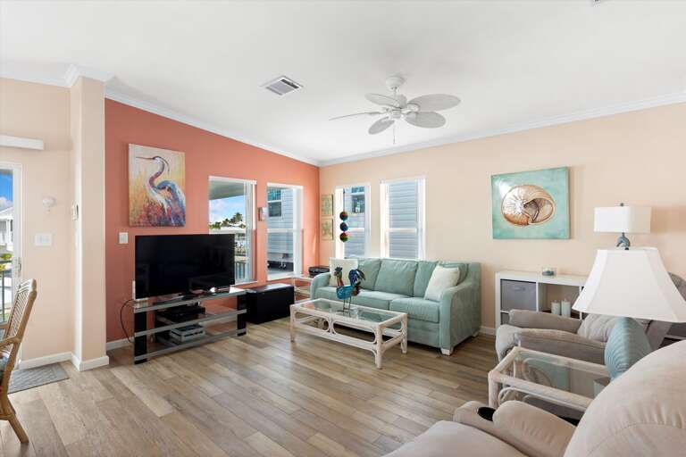 Bright Beach-themed Living Room In Vacation Rental With Pastel Walls And Seaside Decor