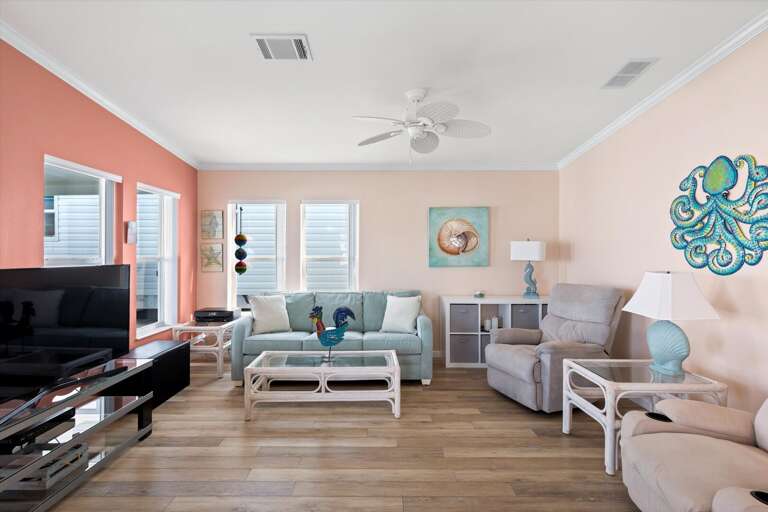 Pastel-painted Living Space With Plush Furnishings And Sleek Surfaces