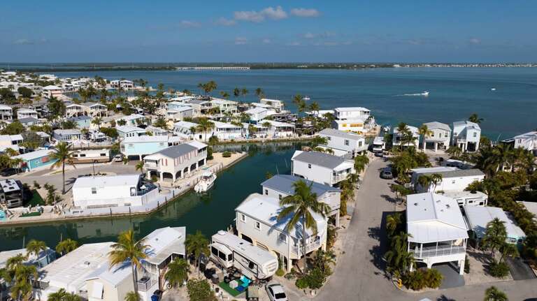 Aerial View Of Seaside Homes Clustered Along A Canal