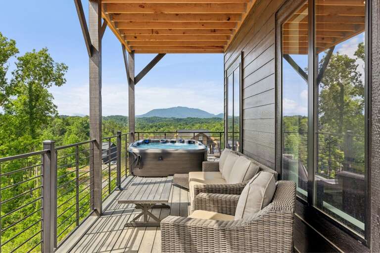 Balcony With Hot Tub And Seating Overlooking Lush Landscape