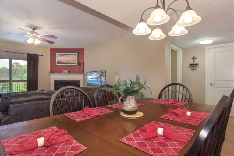 Vacation Rental Dining Area With A Set Table And Fireplace