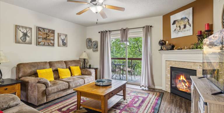 Living Room Layout With Brown Sofa, Yellow Pillows, Fireplace, And Framed Pictures Living Room Layout With Brown Sofa, Yellow Pillows, Fireplace, And Framed Pictures