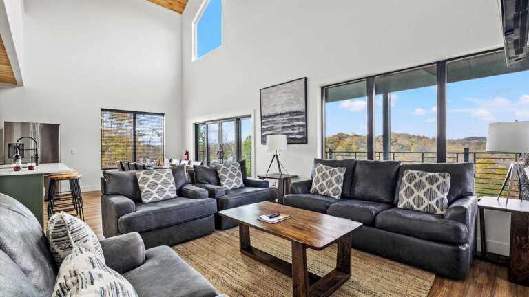 Main entry (middle level) living room, with modern, open kitchen, dining and living room. Living Room features gas fireplace, large SMART TV, and Wifi