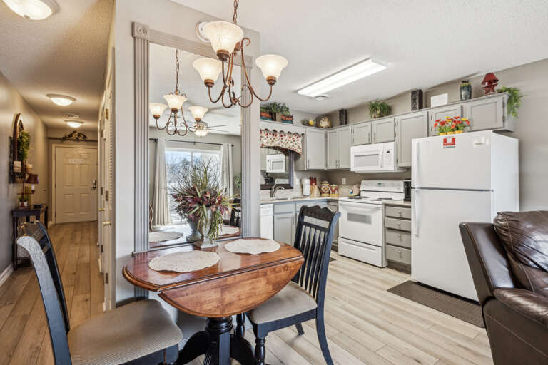 Bright Kitchen, Wooden Table, White Cabinets, Chandelier