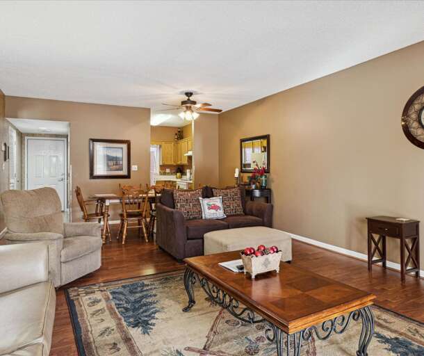 Living Room Layout With Light Furniture, Framed Pictures, And A Floral Rug Living Room Layout With Light Furniture, Framed Pictures, And A Floral Rug