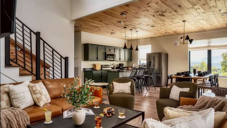 Main entry (middle level) living room, with modern, open kitchen, dining and living room. Living Room features gas fireplace, large SMART TV, and Wifi