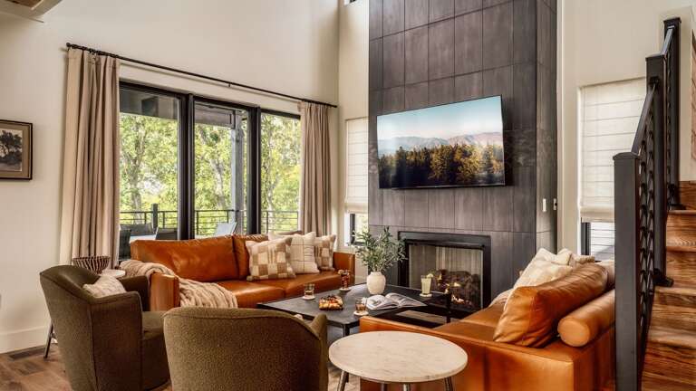 Main entry (middle level) living room, with modern, open kitchen, dining and living room. Living Room features gas fireplace, large SMART TV, and Wifi