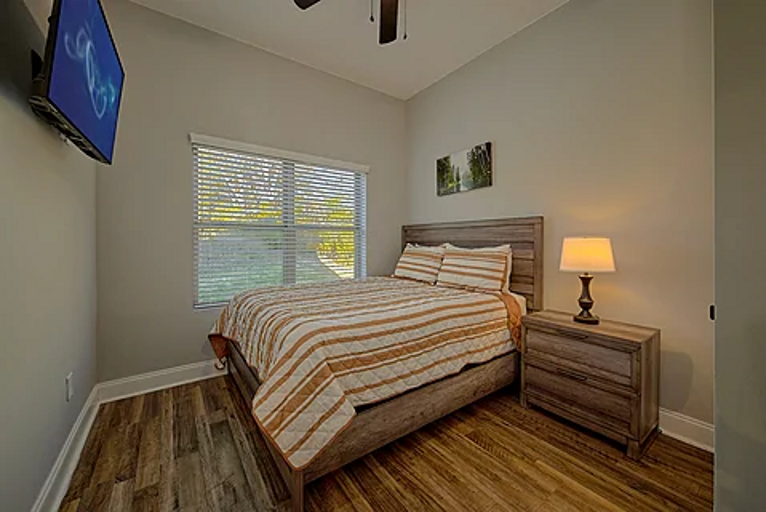 Bedroom with queen bed and tv