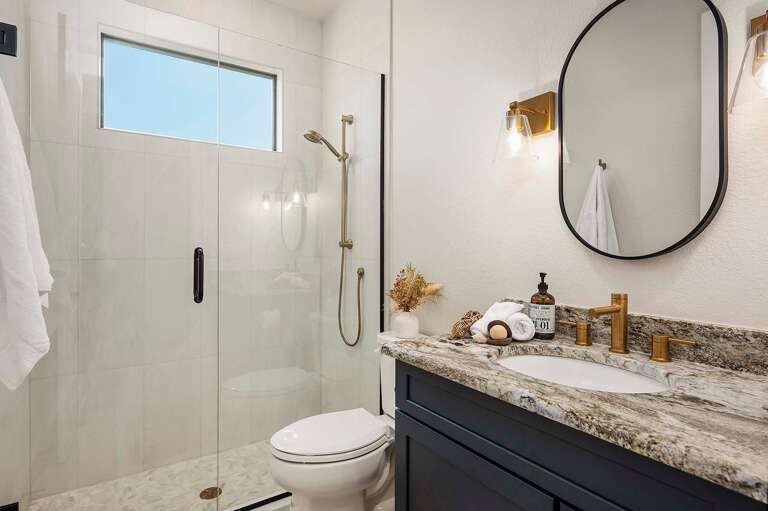 Hallway Bathroom with Walk in Shower and Sink