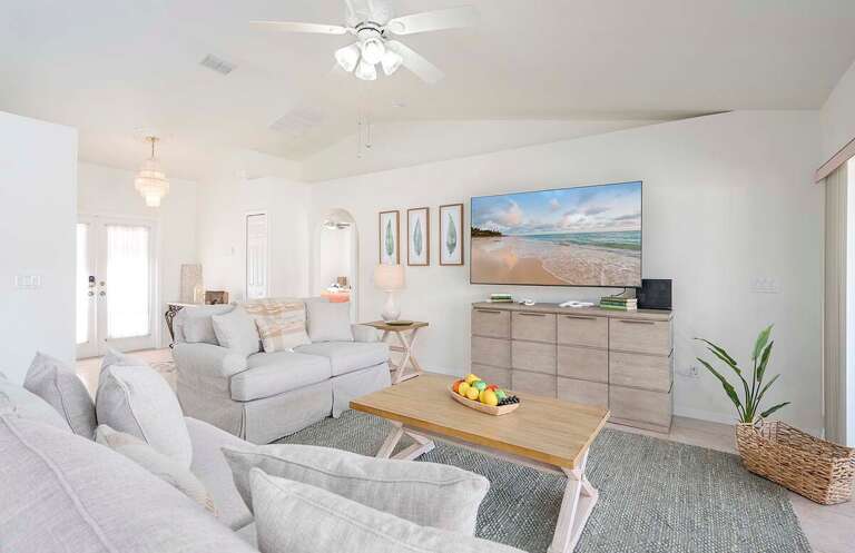Bright And Airy Open Living Room Area with Love Seat and Couch