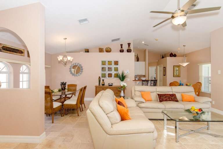 Living Rom with Leather Couches and View of the Pool and Lanai