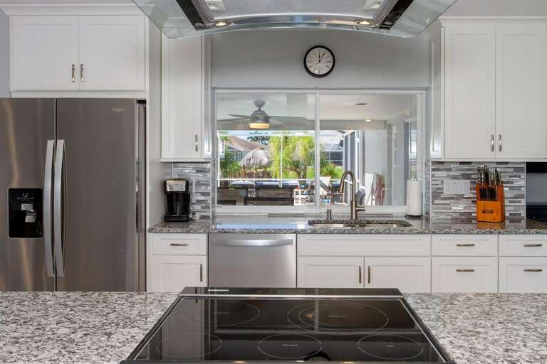 The kitchen features a pass through window to the lanai