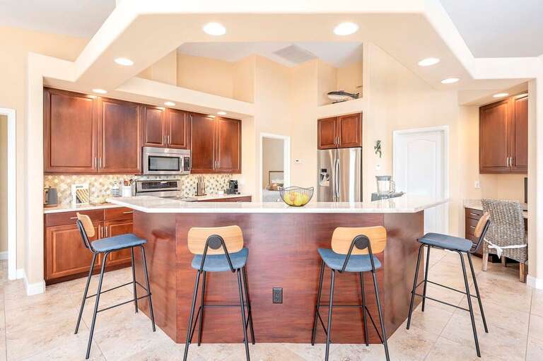 Open Kitchen with Seating at the Bar and a Designated Desk Area