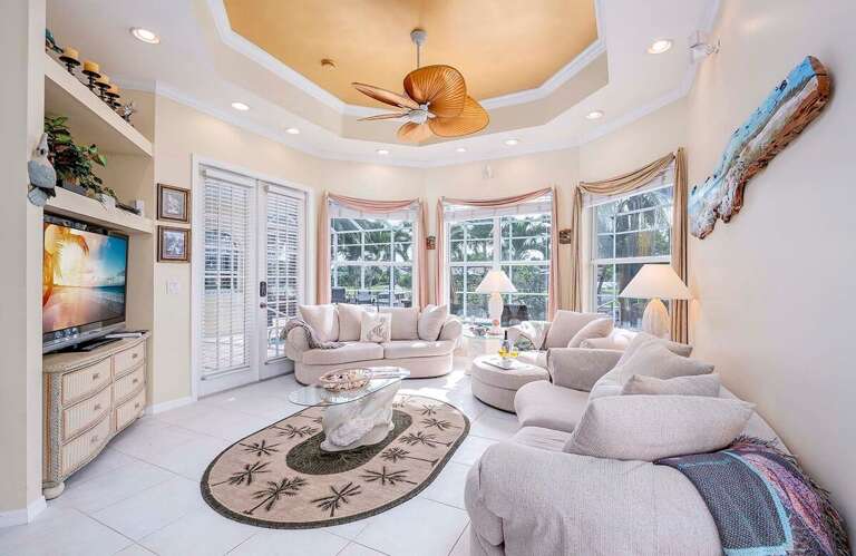 Living Room with French Door Access to Lanai and Views of the Canal