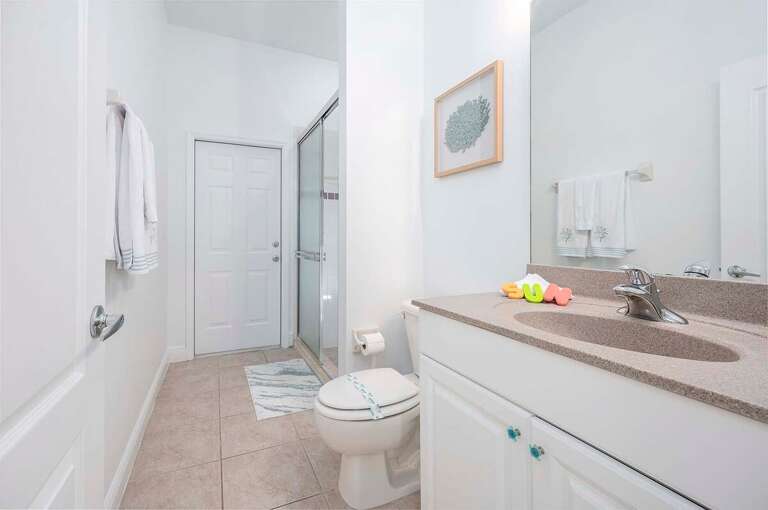Guest Bathroom with walk in shower also serves as Pool Bathroom across from Guest King Bedroom