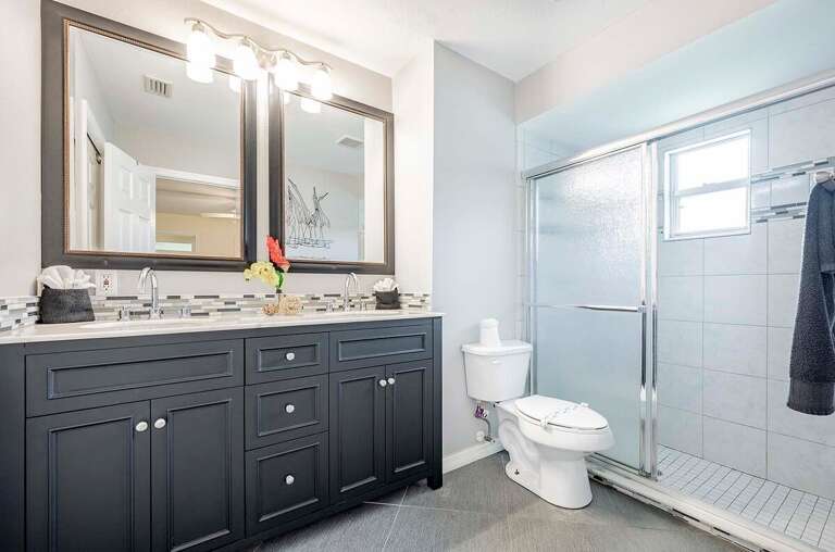 The En-Suite Bathroom features Dual Sinks and a Walk in Shower
