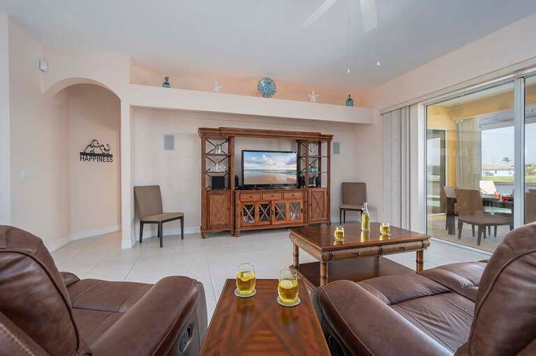 The Living Room Features Amazing Views of the Pool and Canal