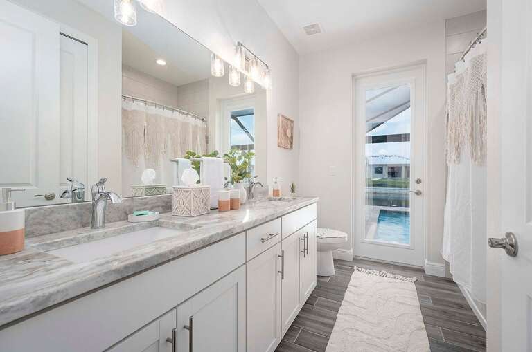 Third Bathroom with Double Sinks and Shower Tub Combo as well as Pool and Patio Access