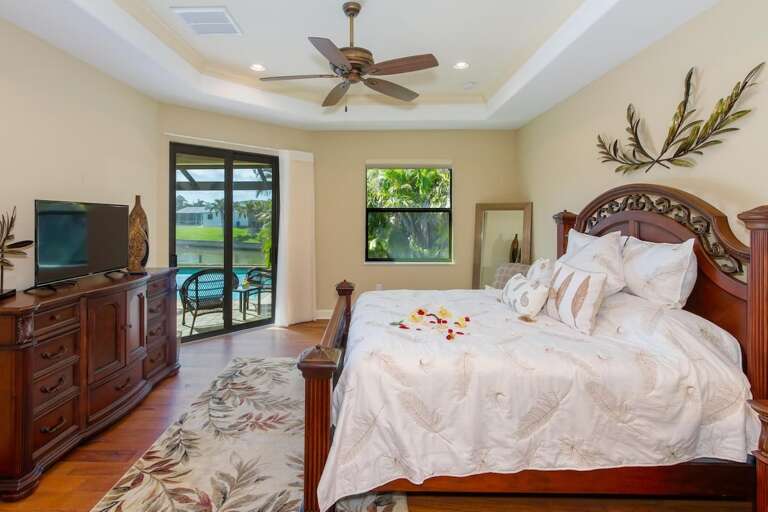 The master bedroom is located on the right side of the house and features a king size bed as well as an en suite bathroom